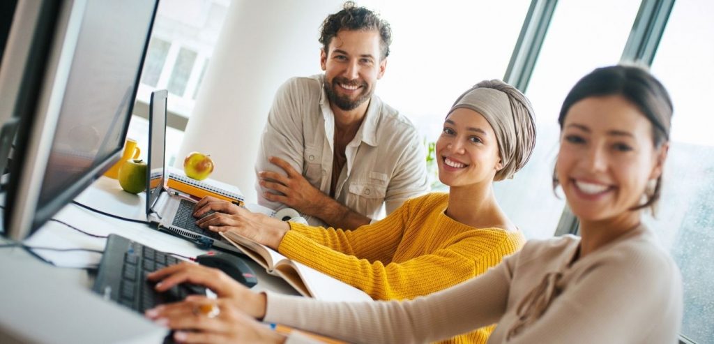 SEO employees smiling as they look into the camera.