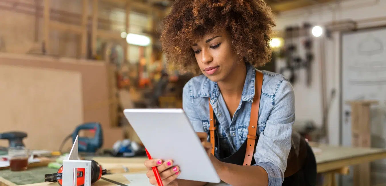 A lady working on a ipad.