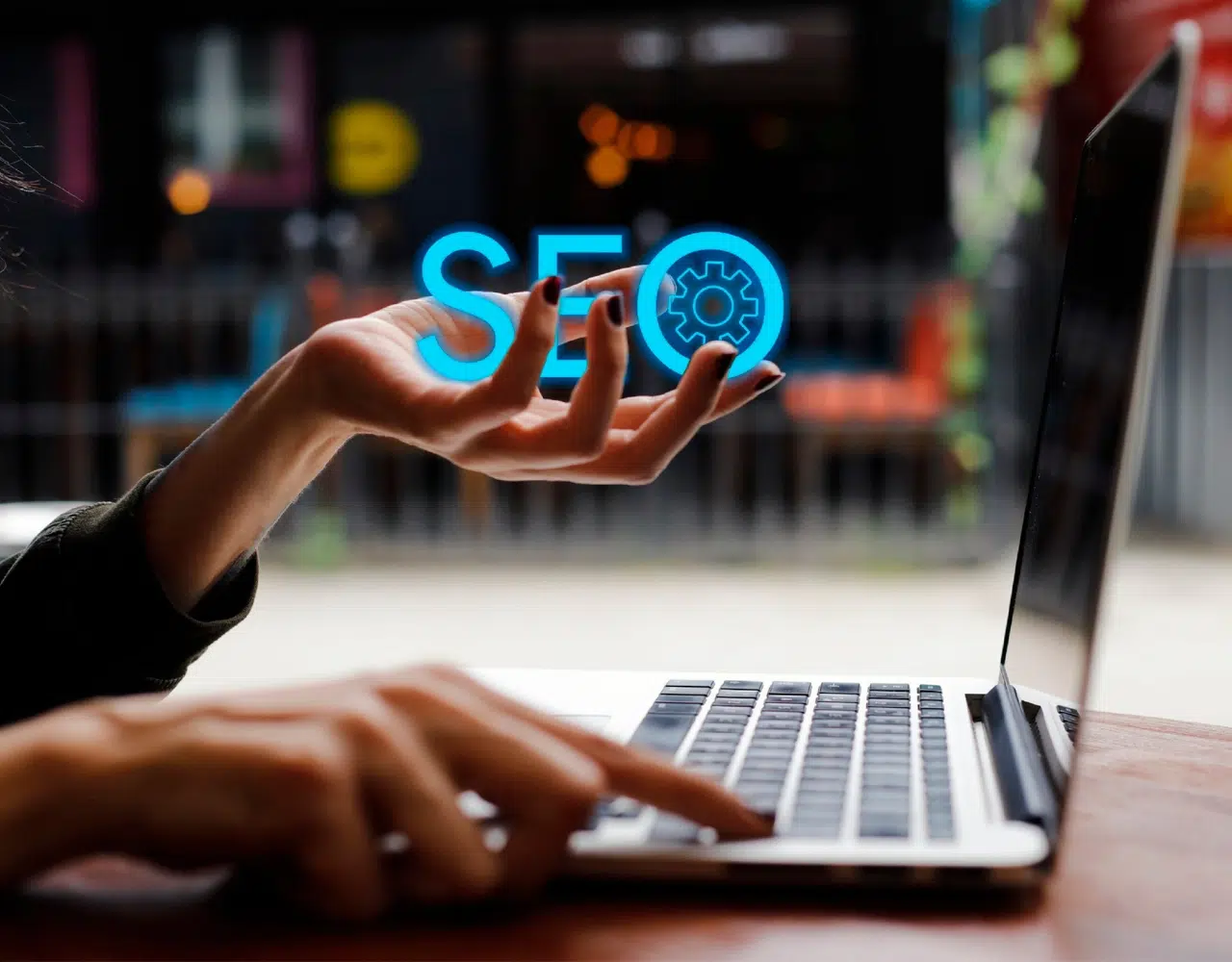 A woman working on a laptop holding SEO Text