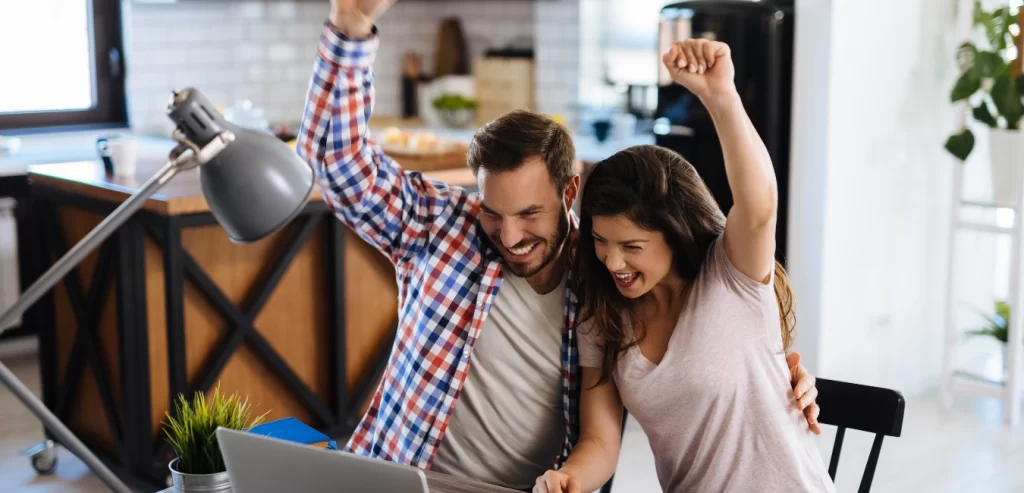 A man and a woman celebrating
 a Google Ad campaign win.